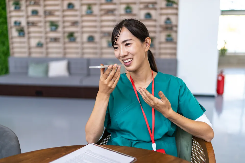 A healthcare professional speaking into a phone