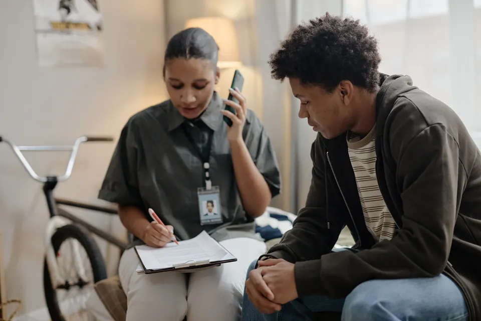 A professional supporting a client during a telephone conversation